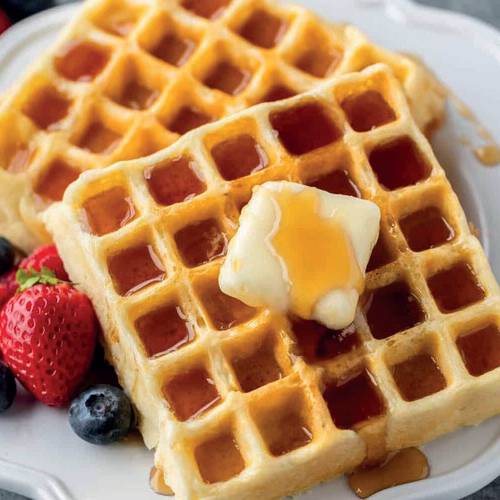 Waffles with syrup, butter, and berries