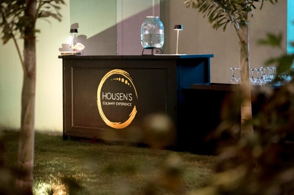 Elegant outdoor dining setup with housens branding