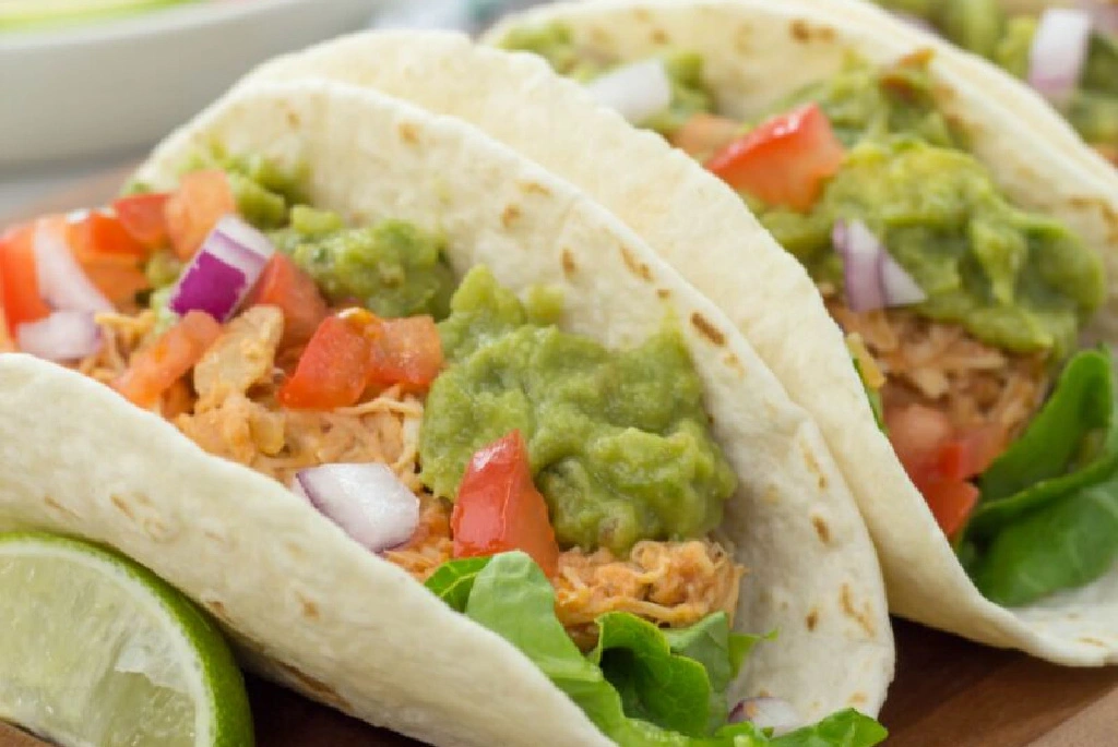 Tacos with chicken, guacamole, and vegetables