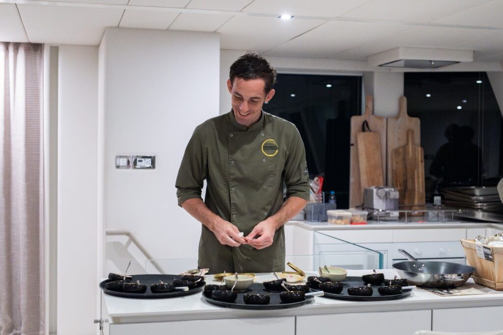 Chef preparing dishes in modern kitchen.