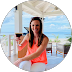 Woman enjoying drink by beach