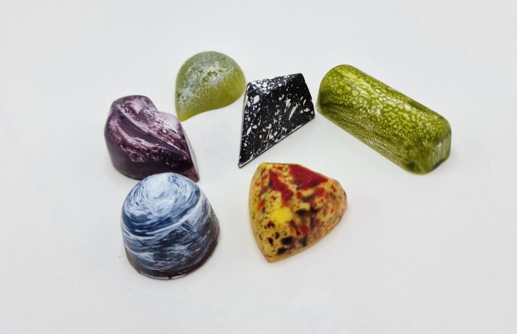 Colorful, artistic chocolate confections arranged.