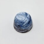 Blue swirled dessert on white background