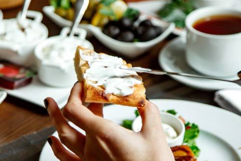 Hand holding slice of breakfast dish
